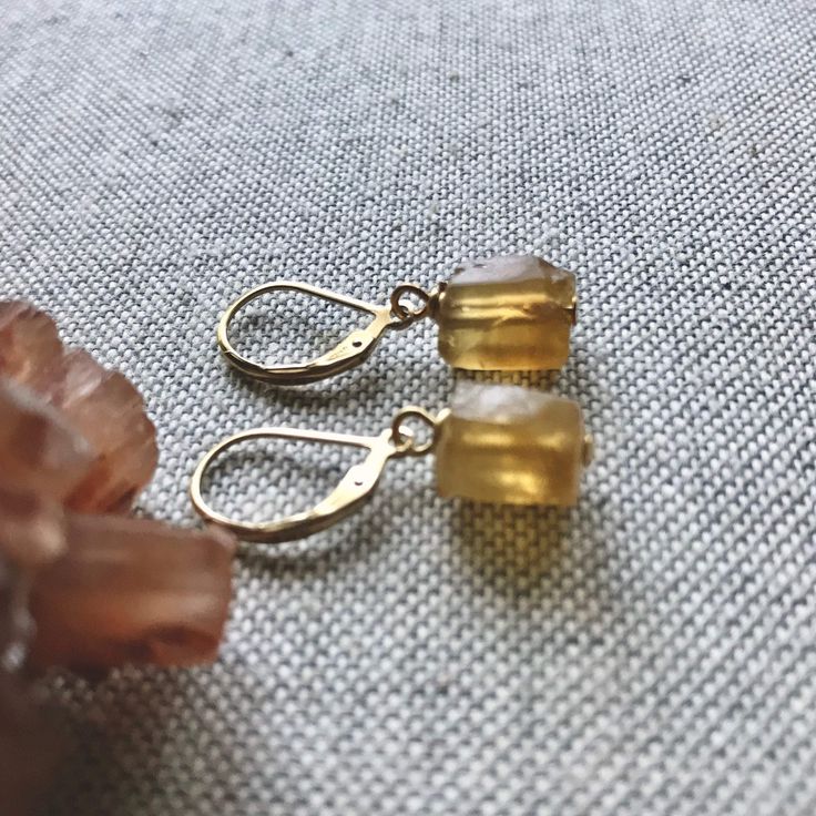 ★Metal- Gold Fill Ear Wires ★Stone- Genuine Raw Citrine ★ 1.2 inches long ★We want you to love your new jewelry and gladly accept returns. ★Arrives ready for gifting (example in last photo) and usually ships same day or next day. Check shop announcement for occasional delays. Gorgeous raw citrine in all it's warm, sunny beauty hang from high quality gold fill lever backs ear wires. Each pair is unique and ready to gift to that someone special. Citrine is the birthstone for November. ✧Metaphysica Amber Dangle Earrings With Ear Wire, Handmade Citrine Dangle Earrings, Handmade Dangle Citrine Earrings, Amber Citrine Teardrop Earrings, Everyday Citrine Gemstone Jewelry, Handmade Citrine Teardrop Earrings, Handmade Teardrop Citrine Earrings, Amber Citrine Earrings With Ear Wire, Teardrop Citrine Jewelry For Gifts