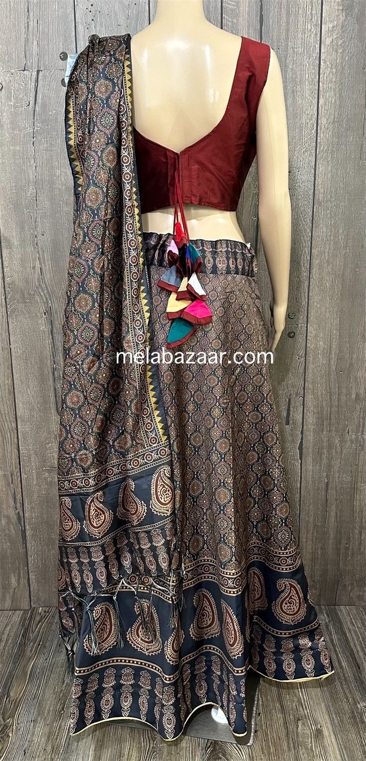 Ajrakh printed chaniya choli set for Navratri/ Garba. Twirl around in this digitally printed Ajrakh skirt on art silk. Skirt: Fits waist upto 38 inches, length 42 inches  Blouse: Size 36 -37 inches, fabric for short sleeves included  Due to seasonal nature of this product, it cannot be returned. Color : Blue Bohemian Chanderi Sets In Traditional Drape, Bohemian Block Print Sharara For Eid, Semi-stitched Bohemian Anarkali Set With Pallu, Bohemian Semi-stitched Anarkali Set With Pallu, Festive Block Print Sharara, Bohemian Chanderi Anarkali Set, Bohemian Chanderi Anarkali Set For Navratri, Bohemian Fitted Sharara With Block Print, Fitted Bohemian Sharara With Block Print