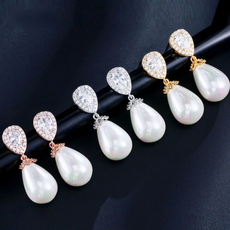 A classy and delicate pair of earrings perfect for the romantic bride, featuring pearls in an iridescent white color and clear cubic zirconia. Electroplated with noble metals (rhodium, 14K rose gold, and 14K yellow gold) for a flawless finish which perfectly enhances the intricate detailing and conveys a modern take on old elegance, these exquisite earrings will add a touch of sophistication to any wedding gown or formal ensemble. Length: 1.25" (approx. 3.2cm); Width: 0.4" (approx. 1cm); Weight: