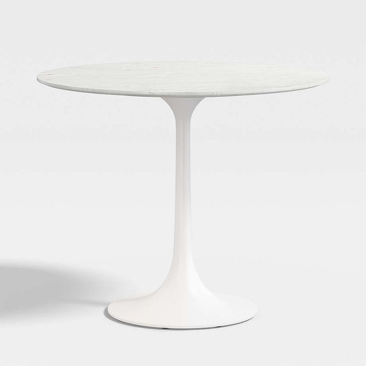 a white table sitting on top of a white floor