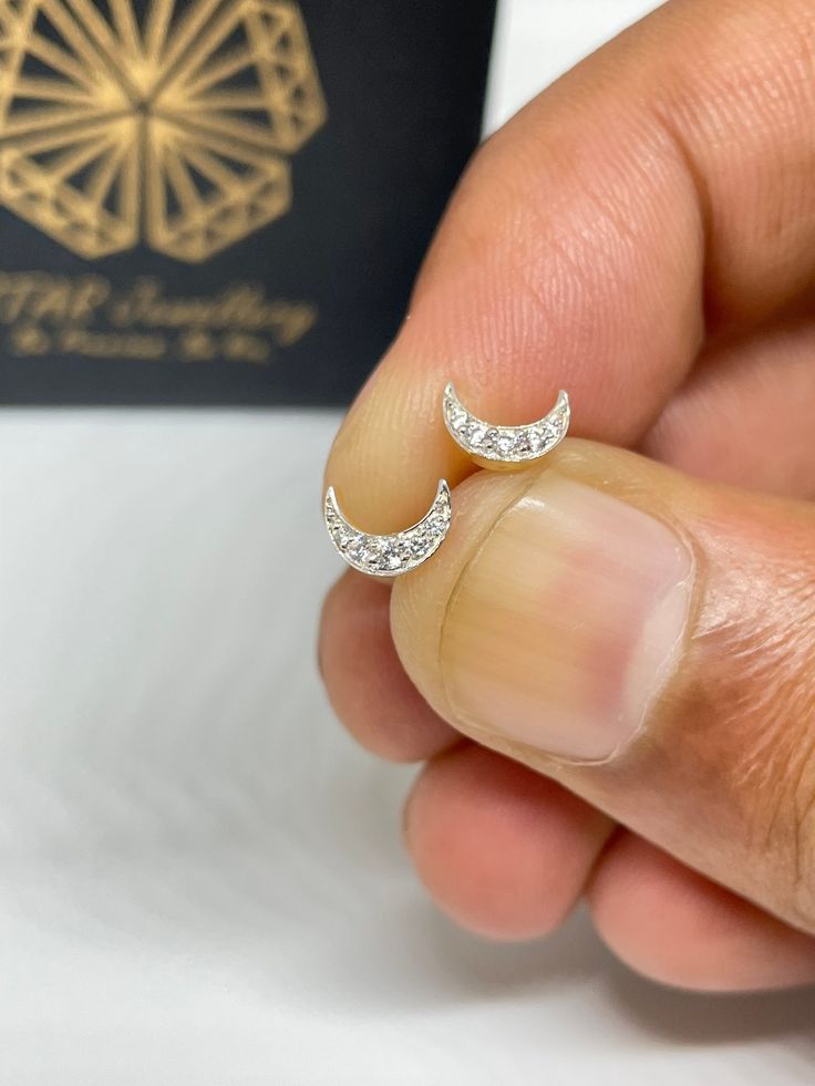 "▶ ITEM SPECIFICATION Diamond Moon Helix Earring, Crescent Moon Tragus Earring, Conch Earring, Cartilage Earring, Diamond Earring, Tiny Earring, Ball end Stud ▶ PRODUCT DETAILS ✦ Diamond Shape : Round Cut ✦ Diamond Pcs. : 5 ✦ Diamond Carat : 0.04 Ct ✦ Diamond Clarity : VVS - VS ✦ Diamond Color : G-H ✦ Setting Type : Pre Pave ✦ Metal Customization: Yellow Solid Gold - White Solid Gold - Rose Solid Gold ✦ Metal Purity - 14K All the piercing jewelry will be customized according to the need of style Crescent Sterling Silver Cartilage Earrings As Gift, Elegant Single Moon Cartilage Earring, Elegant Single Moon-shaped Cartilage Earring, Sterling Silver Cartilage Earrings With Moon Charm For Gift, Moon Shaped Single Cartilage Earring As Gift, Moon Shaped Cartilage Earring As Gift, Moon Shaped Cartilage Earring For Gift, Nickel-free Crescent Cartilage Earrings As Gift, Nickel Free Crescent Cartilage Earrings Gift