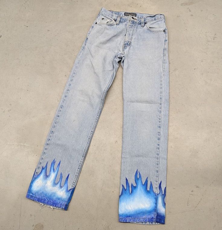 "1 of 1 \"Eternal Blue Flames\" up-cycled vintage denim jeans Size: 29x30 Tag: eflannery.art Comes as is, hand painted design on up-cycled vintage jeans  Measurements are taken in the photos  Message for additional information on the piece or preferred shipping prices  All items ship within 1-3 business days of purchase  Items are preowned unless otherwise stated  Always happy to do discounts on bundles! Happy hunting!!" Flames Painted On Jeans, Blue Upcycled Recycled Denim Jeans, Upcycled Blue Recycled Denim Jeans, Blue Rigid Denim Pants For Summer, Blue Reworked Jeans For Streetwear, Reworked Blue Jeans For Summer, Bleached Blue Denim Jeans, Blue Bleached Denim Jeans, Summer Reworked Blue Jeans