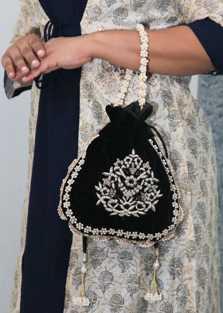 black velvet potli floral pearl flower zardosi handmade embroidery bag for woman | elegant evening woman bag | handmade victorian handbag Designed with the heart, this beautiful Potli or batawa bag are eye catchy and made of premium material. Key Features: Embroidery art work This potli is good match with both Indian and western outfits and are superb for wedding and festive parties This would be best complement to your designer saree, lenhga or any other kind of dress This is the combination of Black Potli Bags, Festival Evening Bag With Pearl Embroidery, Traditional Black Evening Bag For Wedding, Evening Zari Work Potli Bag, Traditional Potli Bag For Evening, Traditional Pearl Embroidered Shoulder Bag For Formal Events, Traditional Evening Potli Bag, Traditional Formal Shoulder Bag With Pearl Embroidery, Festive Shoulder Bag With Pearl Embroidery