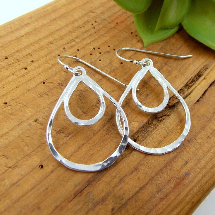 These Double Loop Lace Earrings are made from solid sterling silver earrings, given a hammered finish, and polished to a beautiful shine. Solid Sterling Silver Approx. 0.8 inches (2cm) wide Approx. 1.2 inches (3.05cm) long not including hooks Silver Teardrop Earrings With Polished Finish For Gift, Hammered Sterling Silver Jewelry, Sterling Silver Teardrop Hoop Earrings With Polished Finish, Modern Hammered Drop Jewelry, Silver Sterling Teardrop Earrings With Polished Finish, Hammered Sterling Silver Drop Jewelry, Hammered Drop Sterling Silver Jewelry, Modern Sterling Silver Hammered Earrings, Modern Hammered Sterling Silver Earrings