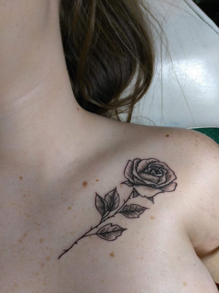 a woman with a rose tattoo on her chest