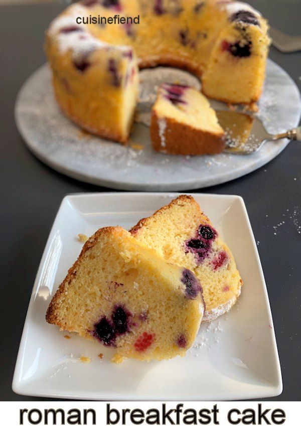 two plates with slices of cake on them, one has blueberries and the other has lemon