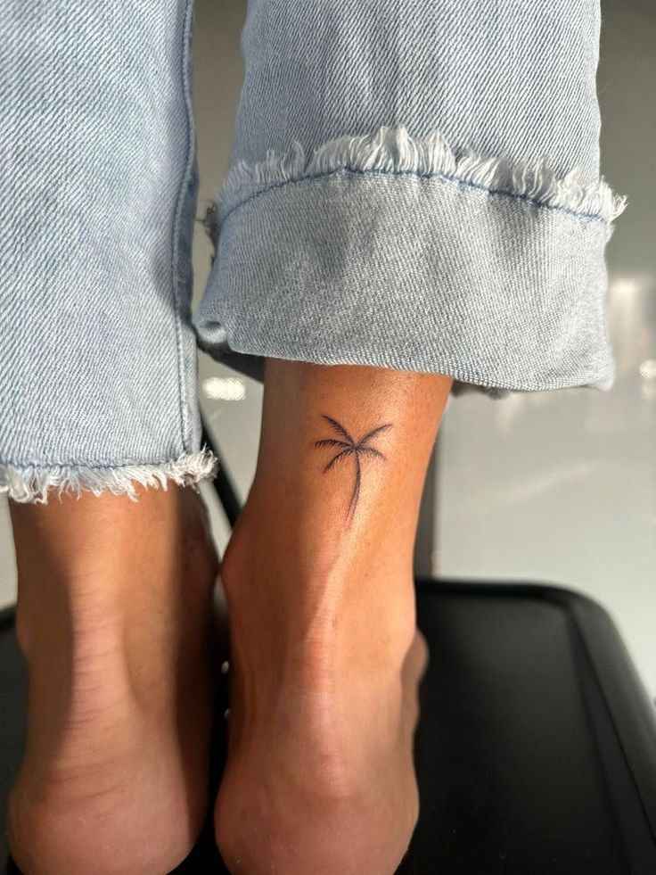 a woman's foot with a small tattoo on the side of her left leg