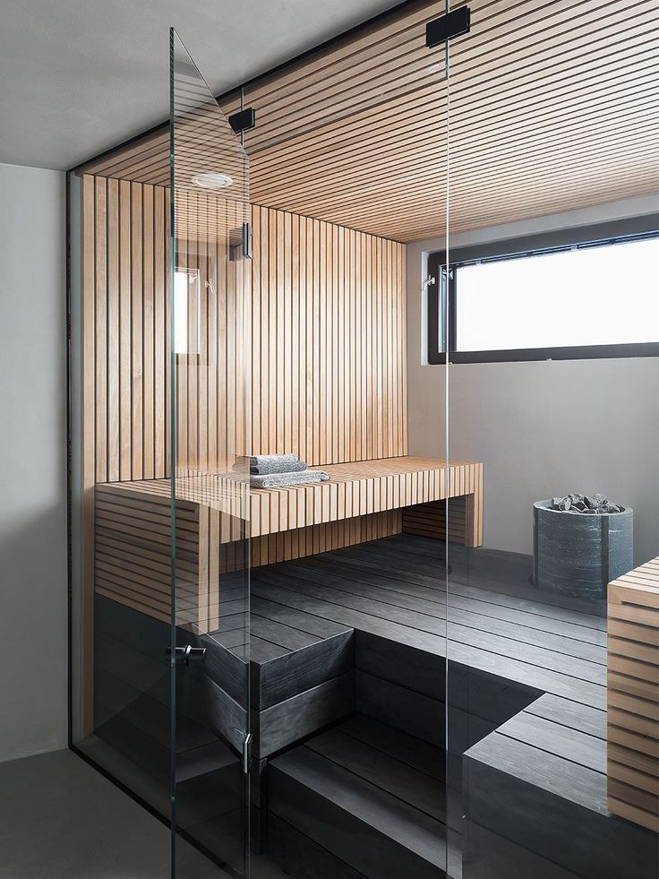 a bathroom with wooden walls and flooring next to a bathtub in the corner