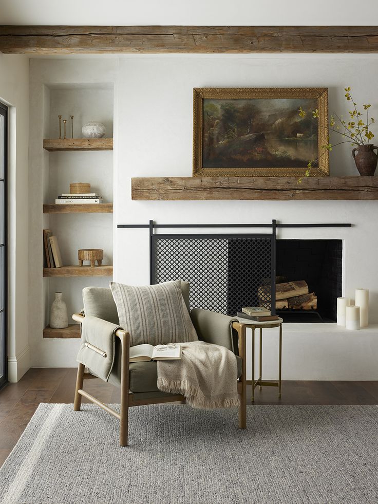 a living room filled with furniture and a fire place next to a painting on the wall