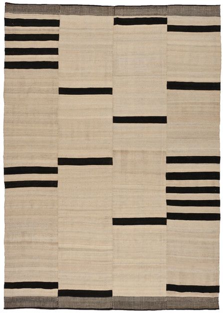 an area rug with black and white stripes on it, in the shape of squares