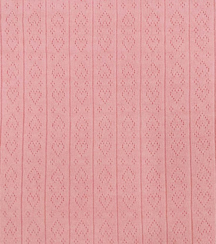 pink knitted fabric textured with small dots and lines, suitable for background or wallpaper