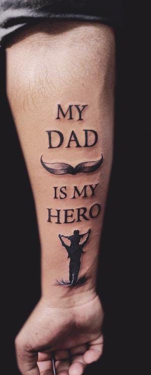 a man with a tattoo on his arm that says, my dad is my hero