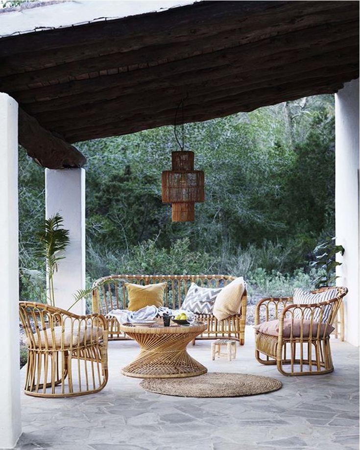 an outdoor seating area with wicker furniture