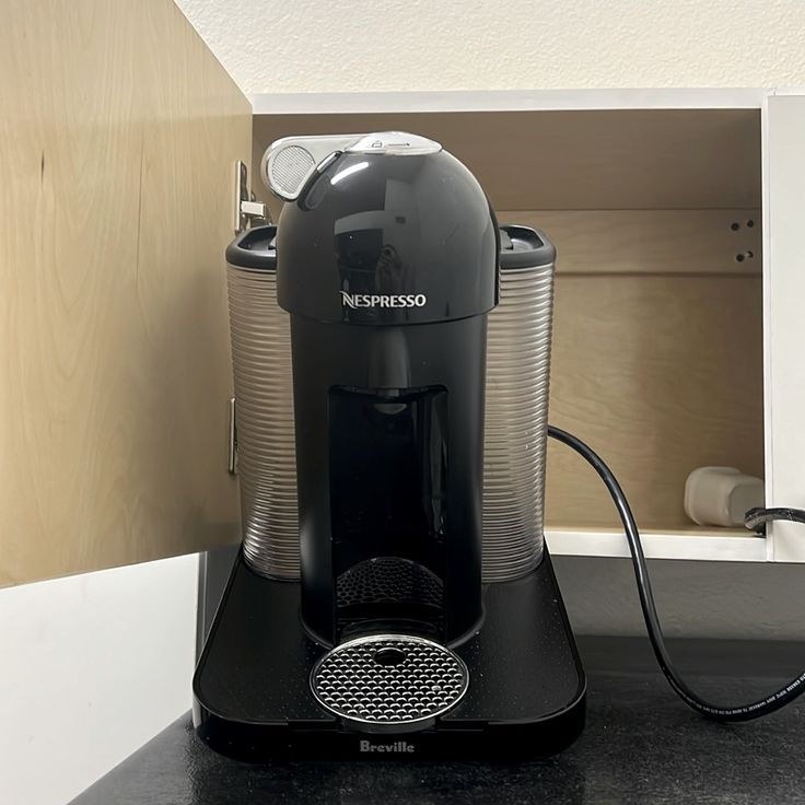 a black coffee maker sitting on top of a counter