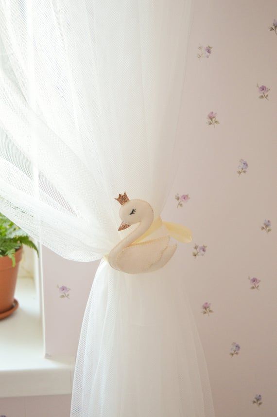 there is a stuffed swan on the curtain