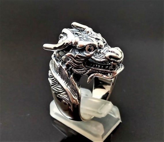 Chinese Dragon RingPure 925 Sterling Silver Unisex Ring with Black Onyx EyesThis beautiful Exclusive Design Dragon Ring has been Fabulously casted with .925 Sterling SilverThe weight of the Ring is 27-28 grams*please inquire if you don't see your size listed*Please allow 2-3 weeks shipping as we are in Bangkok Thailand at this timeWe are a Los Angeles based company operating out of Thailand so that we may bring you the highest quality items at the most competitive prices. Just search and compare Silver Dragon Design Jewelry For Formal Occasions, Formal Silver Jewelry With Dragon Design, Silver Jewelry With Dragon Design For Formal Occasions, Traditional Black Jewelry With Polished Finish, Traditional Black Sterling Silver Rings, Black Jewelry With Dragon Design Collectible, Collectible Black Jewelry With Dragon Design, Traditional Silver Jewelry With Dragon Design, Black Spiritual Jewelry With Dragon Design