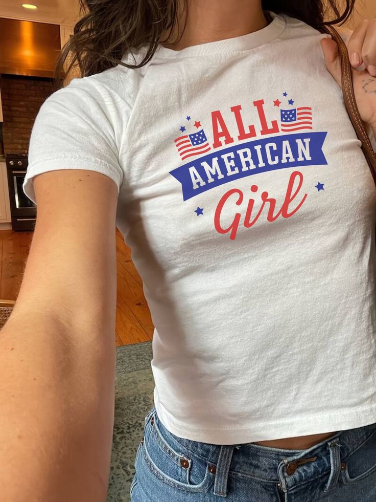 All American Girl! Proud American Independence Day Red White and Blue Shirt. Patriotic Gift Shirt Baby Tee! Get ready to channel some nostalgic vibes with this 90s aesthetic baby tee! Whether you're heading to a music festival or simply hanging out with friends, this top is sure to be a standout addition to your wardrobe. Bring back the 90s in style with this adorable baby tee! This baby tee comes in youth sizes. this is traditional for 90's baby tees. this is a miniaturized t-shirt different fr White Top With Text Print For 4th Of July, White Text Print Top For 4th Of July, White Tops With Text Print For 4th Of July, Trendy Pre-shrunk Tops For 4th Of July, 4th Of July Cotton Slogan Tops, Cotton Slogan Tops For 4th Of July, Trendy Cotton Tops For 4th Of July, Cute American Flag Print Short Sleeve T-shirt, White Y2k Pre-shrunk Tops