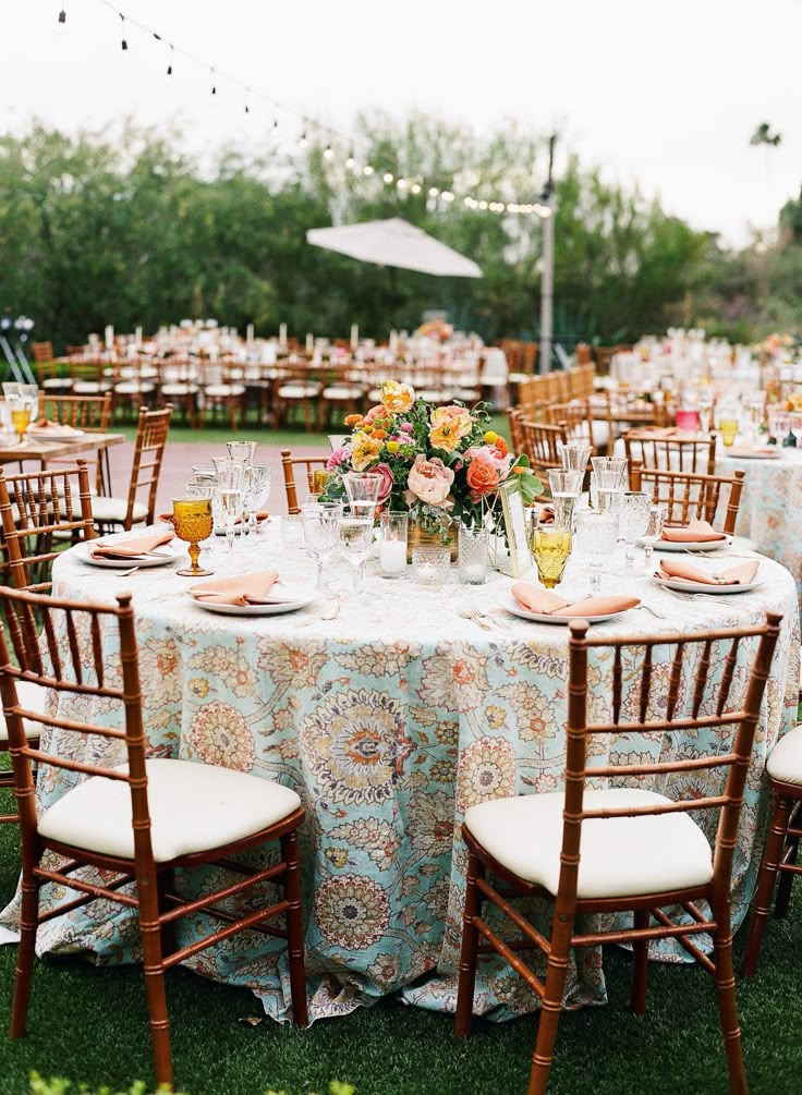 a table set up for an outdoor wedding reception