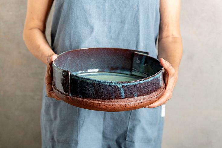 a person holding a bowl in their hands