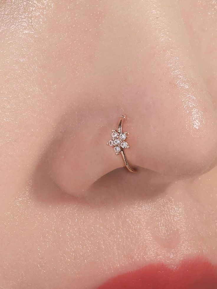 a close up view of a nose with a diamond ring on it