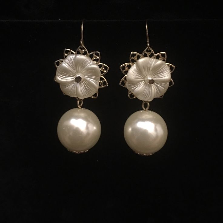 Dangling Pearl And Gold Toned Earrings Formal Pearl White Flower Drop Earrings, Party Pearl Drop Flower Earrings, Elegant Silver Pearl Flower Earrings, Elegant Flower Clip-on Earrings For Party, Pearl White Dangle Earrings For Party, Metal Drop Flower Earrings For Evening, Round Flower Earrings For Parties, Elegant White Hypoallergenic Clip-on Earrings, Elegant Floral Clip-on Earrings For Formal Occasions