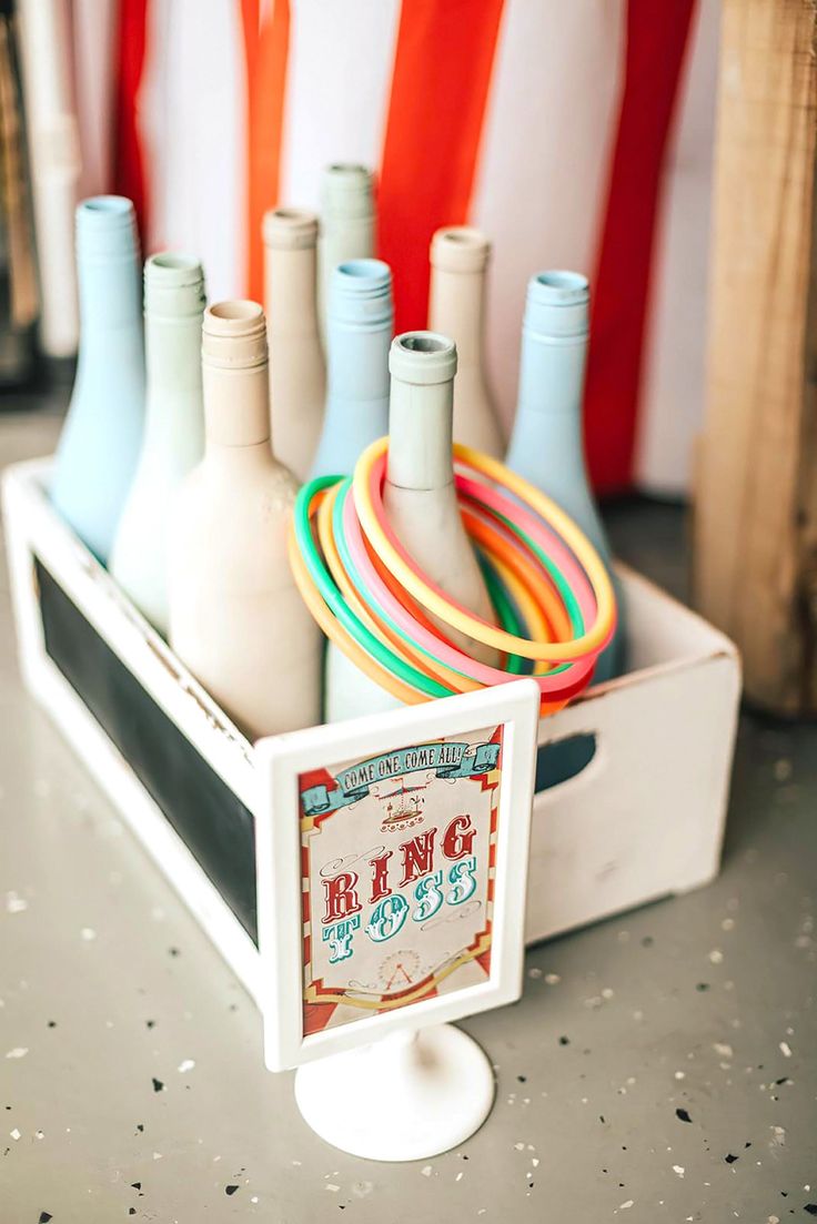 there are many different colored bowling pins in the holder on the table and one is empty