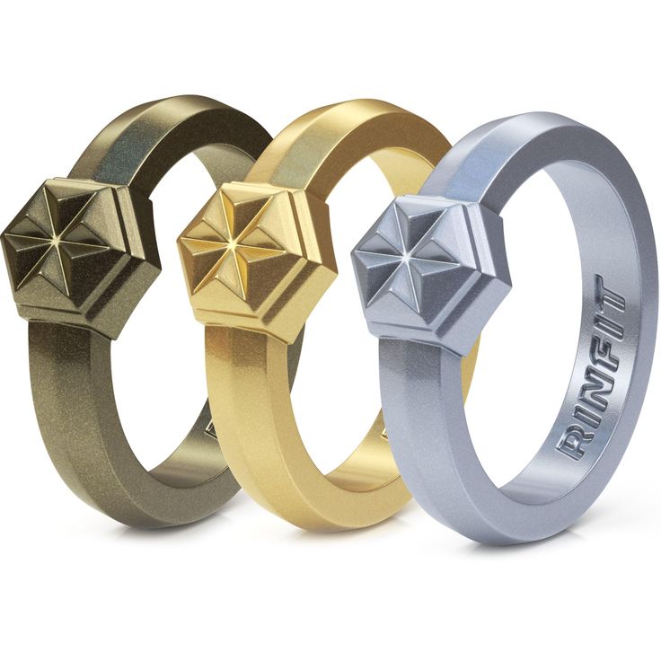 three different colored rings with pyramids on them