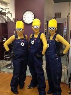 three people in overalls standing next to each other with their hands on their hips