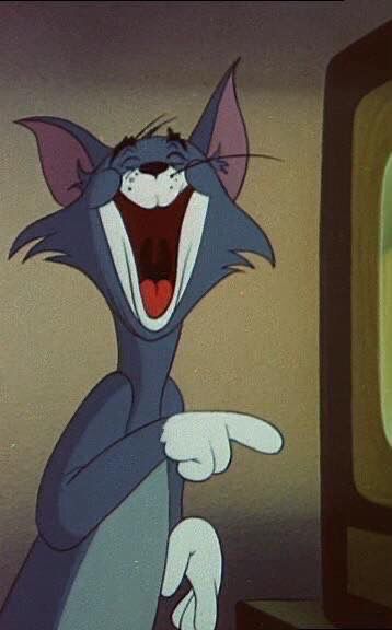 an animated cat with its mouth wide open in front of a television screen and pointing at it