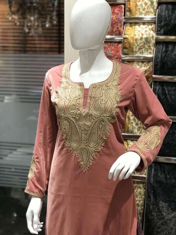 Style up with this elegant velvet kurta with Kashmiri Tilla embroidery. Pair this Tunic Top Kurta with a skirt, trousers, jeans, jeggings, dhoti or any other bottom and be ready in style.- - - - - - - - - - - - - - - - - - - - Product DetailsVelvet Kurta with Kashmiri Tilla Embroidery (Metallic Thread)- Condition: Brand New (Made to Order)- Fabric: Fine Velvet- Fully Lined from Inside- Features Pockets on both sides.- Colour: Peach- Length: 40" (102 cms approx, the mannequin is 6ft tall).- Care Festive Long Sleeve Kaftan With Zari Work, Velvet Straight Kurta With Resham Embroidery, Velvet Resham Embroidery Straight Kurta, Festive Velvet Straight Kurta, Festive Semi-stitched Long Sleeve Kaftan, Bollywood Style Straight Velvet Kurta, Festive Long Sleeve Semi-stitched Kaftan, Traditional Velvet Kurta With Zari Work, Unstitched Velvet Traditional Kurta