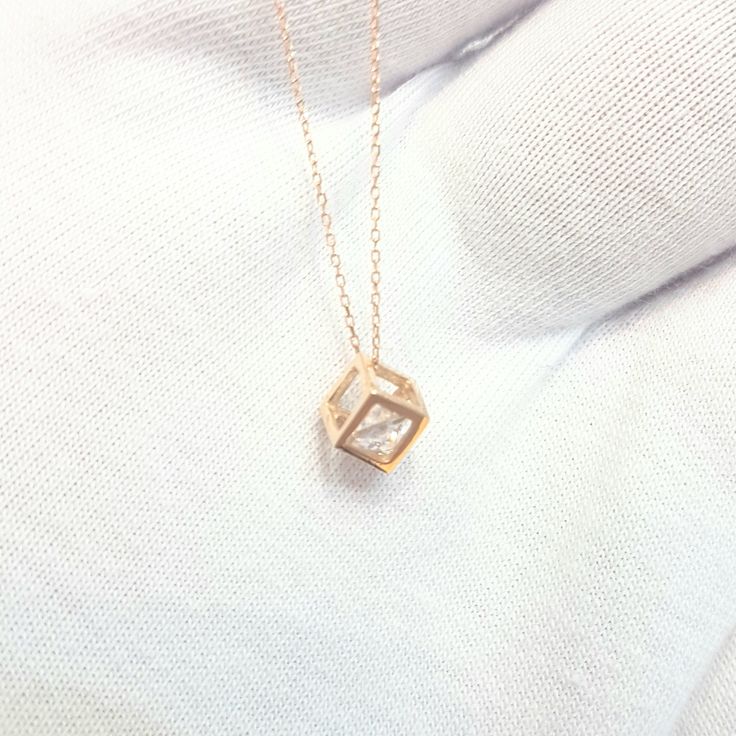 - Cube pendant necklace is made with high-quality 14K real solid gold. - The Inside of the cube, there is a diamond cut cubic zirconia stone and it is moving. - The dimensions of the cube is 0.5 X 0.5 X 0.5 cm. - This dainty, charm, tiny, delicate, cute and trendy pendant necklace has been artfully designed for timeless yet modern millennial fashion. - This 14K solid gold pendant comes with a beautiful matching free 14K real solid gold chain. - You receive the pendant in a beautiful and free gif Cubic Zirconia Square Pendant Necklace For Gifting, Square Pendant Solitaire Necklace With Diamond Cut For Gift, Rose Gold Pendant Necklace With Box Chain, Diamond Cut Solitaire Necklace With Square Pendant For Gifts, Square Diamond Cut Solitaire Necklace As Gift, Rose Gold Diamond Clavicle Necklace As Gift, Diamond Cut Solitaire Necklace With Square Pendant, Gift Diamond Necklace With Square Pendant, Fine Jewelry Diamond White Chain Necklace Gift