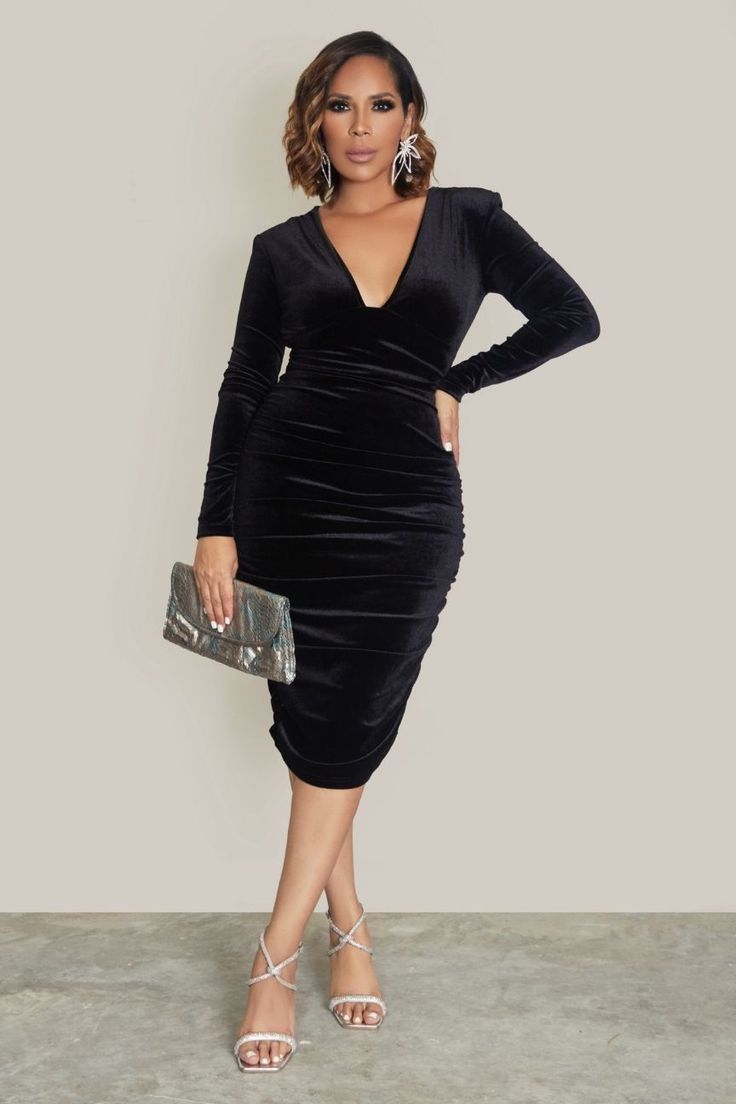 Elevate your party style with our Liora Deep V Neck Ruched Velvet Bodycon Dress in classic Black. This dress is a showstopper, designed to make a bold statement at any event.The deep V-neckline adds a touch of allure, while the long sleeves type bring an elegant sophistication to the look. Crafted from luxurious velvet fabric, the dress is both opulent and comfortable.The standout feature is the exquisite ruched detailing that enhances your silhouette, creating a figure-flattering effect. The na Fitted Ruched Knee-length V-neck Dress, V-neck Ruched Bodycon Dress For Party Season, Glamorous V-neck Bodycon Midi Dress, Elegant V-neck Dress For Date Night And Party Season, Elegant V-neck Dress For Date Night Party, Elegant Ruched V-neck Cocktail Dress, Chic Fitted V-neck Dress For Dinner, Fitted V-neck Midi Dress For Holiday Party, Glamorous Ruched Midi Dress For Dinner