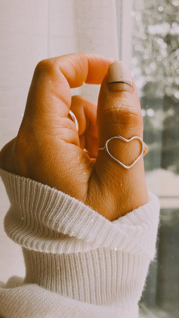 These have wonderful details and are a fun accessory to wear anytime, anywhere!!Item Details: • This listing is for ONE(1) Sterling Silver Heart Ring.• We hand hammer and hand forge this heart ring. the photos are a representation of what will be custom made for you. This heart ring is totally handmade one by one. Each heart comes in a slightly different shape and has its own character. made with lots of love.• All our work is custom made by hand in our Coco Wagner, KS studio. SHOP + MORE RINGS Open Heart Ring, Silver Heart Ring, Shiny Objects, Tarnished Jewelry, Jewelry Accessories Ideas, Thumb Ring, Minimal Jewelry, Silver Rings Handmade, Open Heart