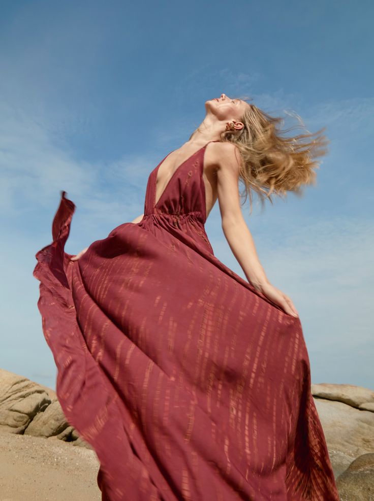 Embrace dreamy vacation vibes any time of the year with this tie-dye halter neck maxi dress in burgundy. Designed for long, carefree days under the sun, the Luna Maxi Dress strikes the balance between stylish and comfortable. Featuring a jaw-dropping deep V-neck and a head-turning open back, this maxi dress gives you a slender, elongated silhouette that you’ll love. The almost fluidic softness of the fabric and the delicate flow of the full-length hemline give you an effortlessly graceful look.W Bohemian Red Halter Dress For Summer, Red Bohemian Halter Dress For Summer, Summer Sleeveless Burgundy Maxi Dress, Sleeveless Burgundy Maxi Dress For Summer, Burgundy Beach Dress For Summer, Vacation Festival Dresses With Halter Neck, Flowy Burgundy Dresses For Summer, Burgundy Bohemian Summer Dress, Bohemian Burgundy Summer Dress