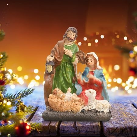 a nativity scene with the birth of jesus and baby jesus in front of a christmas tree