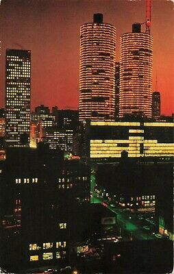 the city skyline is lit up at night with bright lights and skyscrapers in the background