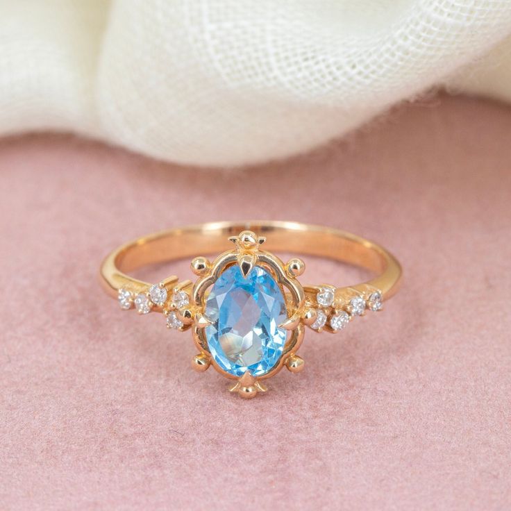 Embrace timeless elegance with our Swiss Blue Topaz Gold Ring, a stunning piece that radiates sophistication and grace. This exquisite ring, reminiscent of vintage style promise rings, captivates with its enchanting Swiss blue topaz gemstone.  Whether as an engagement ring symbolizing eternal love or a promise ring marking a cherished commitment, its beauty is undeniable. Crafted with meticulous attention to detail, this Swiss blue topaz ring is sure to become a treasured heirloom, adding a touc Luxury Light Blue Topaz Ring For Wedding, Luxury Light Blue Topaz Wedding Ring, Elegant Light Blue Topaz Ring With Prong Setting, Elegant Light Blue Topaz Ring With Accent Stones, Elegant Blue Topaz Ring With Gemstone Accents, Elegant Light Blue Sapphire Ring With Accent Stones, Elegant Light Blue Sapphire Ring With Center Stone, Elegant Light Blue Sapphire Ring, Elegant Light Blue Promise Ring