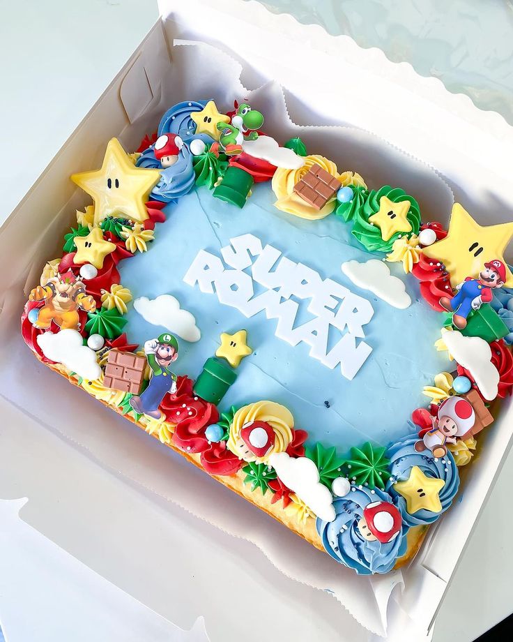 a cake in a box with the word super mario on it