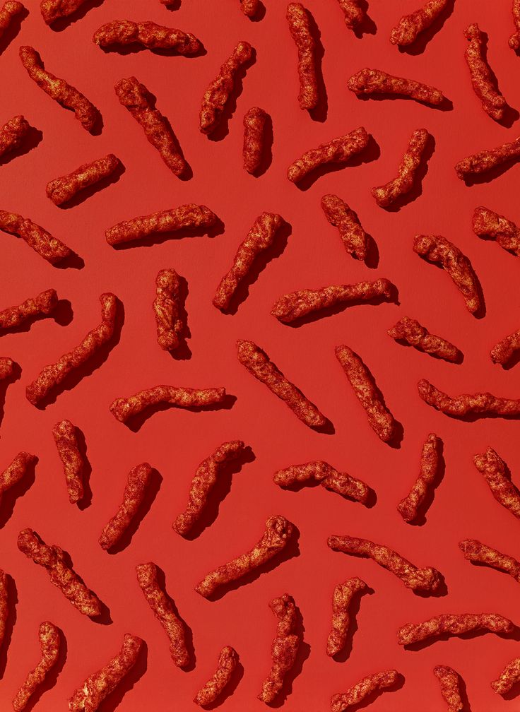 an image of some kind of food on a red surface that looks like it is made out of meat