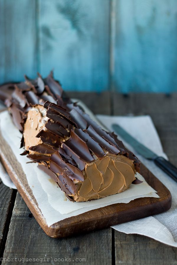 a piece of chocolate cake sitting on top of a white plate next to a knife