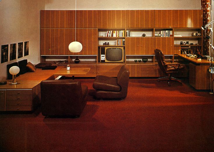 a living room filled with furniture and a flat screen tv sitting on top of a wooden table