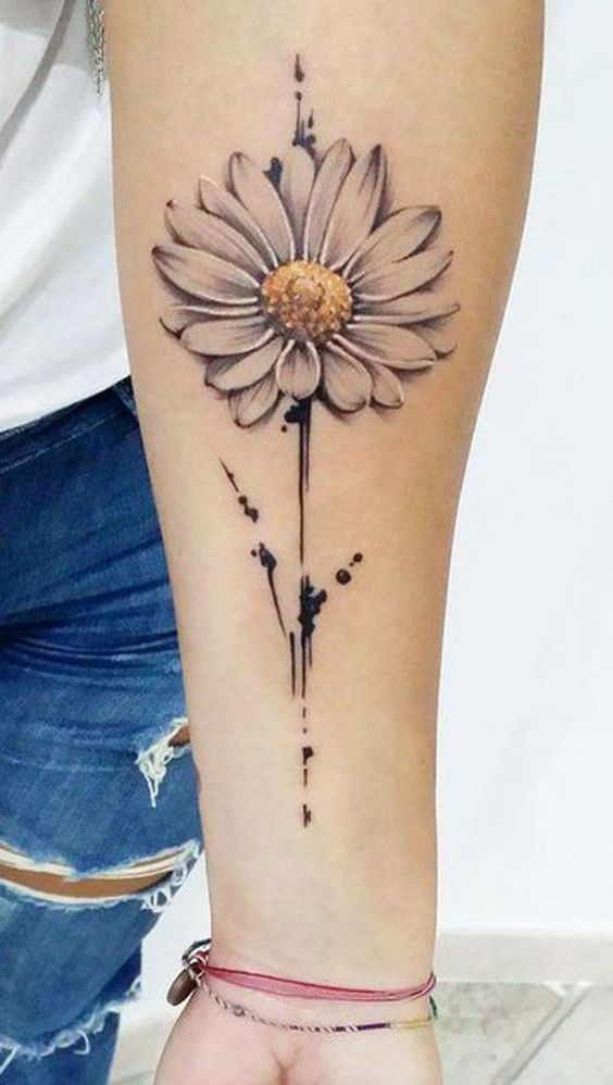 a woman's arm with a tattoo on it and a flower in the middle