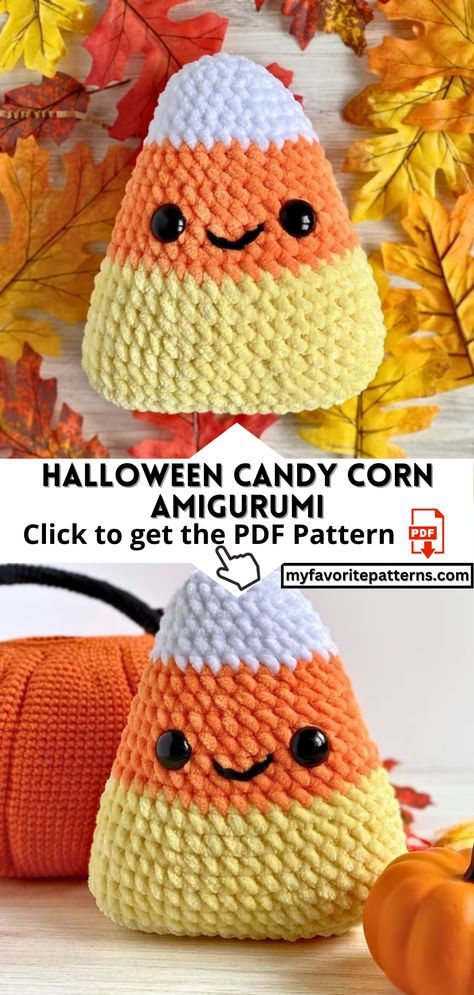 an orange and white crocheted candy corn on top of a wooden table with fall leaves