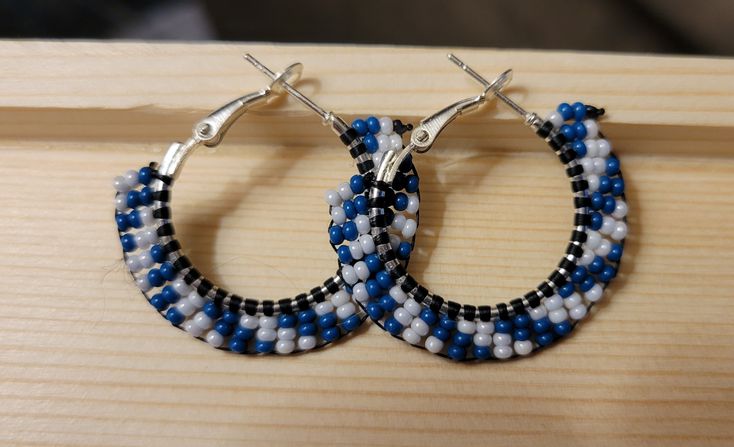 These sakonige (blue in Cherokee) swirl beaded earrings can add a little whimsy to your holiday outfit. Other colors available under "variations". Handmade Blue Round Hoop Earrings, Blue Beaded Round Hoop Earrings, Handmade Blue Beaded Small Hoop Earrings, Handmade Small Hoop Blue Earrings, Handmade Small Blue Hoop Earrings, Blue Beaded Small Hoop Earrings, Small Blue Beaded Hoop Earrings, Small Hoop Earrings With Colorful Beads In Blue, Handmade Blue Beaded Hoop Earrings