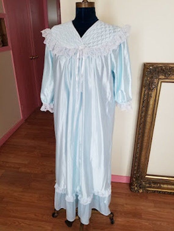 Vintage 70's Powdered Satin Blue High Sheen Long Sleeve V Neck Nightgown with Lace Beautiful Size M /L Beautiful!! So lovely and in very good consition even if the tag is all erased. The interior is super soft coton and the exterior is satin. ❤ Please note you can choose from 13 different shipping methods for those items, you need to scroll down on the shipping to see the different options 🥰 thank you so much to pick the one who fits the best for you.   Great care and attention go into selectin Light Blue Nightgown For Home, Vintage Blue Dress For Sleepover, Light Blue Lace Trim Nightgown, Light Blue Lace Trim Nightgown For Home, Vintage Blue Nightgown For Home, Vintage Blue Nightgown For Bedtime, Vintage Blue Sleepwear For Pajama Party, Blue Vintage Nightgown, Beautiful Nightgown