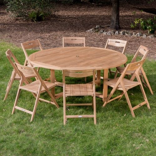 a wooden table and chairs sitting in the grass