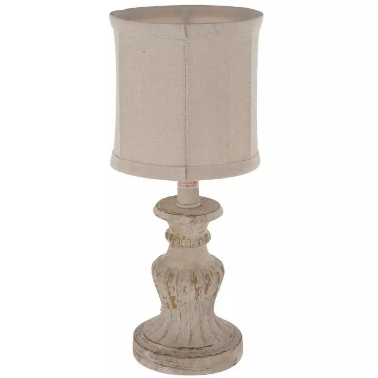 a white table lamp with a beige shade