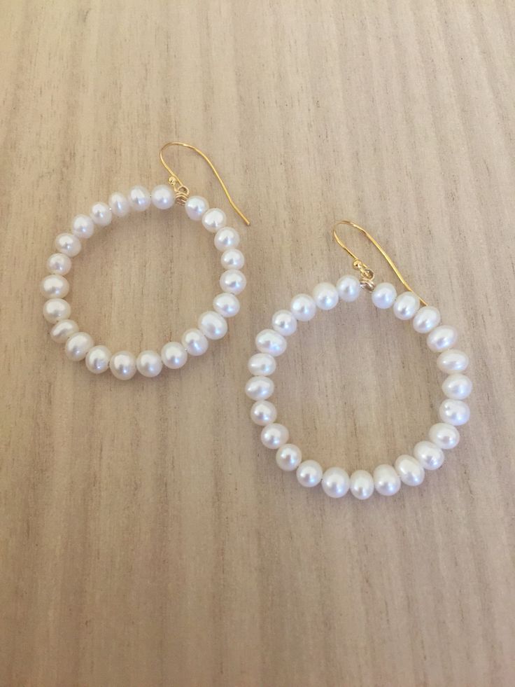 "Hoop earrings are always fun, and certainly kicked up a notch when the hoops are covered in pearls! 14K gold plated sterling silver wire is used to form the hoops. Luscious 4-4.5mm white cultured freshwater pearls circle up for a fun and flirty or dressy and classic earring. Approximate diameter is 1.25\". Gold plated sterling silver French ear wire settings allow the hoops to dangle freely. Handmade in Charleston SC, single person small business" Small Hoop Pearl Earrings, Small Hoop 14k Gold Filled Pearl Earrings, White Pearl Drop Hoop Earrings In 14k Gold, Pearl Small Hoop Earrings With Ear Wire, Small Hoop Pearl Earrings With Ear Wire, Everyday Hoop Pearl Earrings With Ear Wire, Small Hoop Pearl Drop Earrings In 14k Gold Filled, Everyday Pearl Hoop Earrings With Ear Wire, 14k Gold Filled Pearl Charm Hoop Earrings