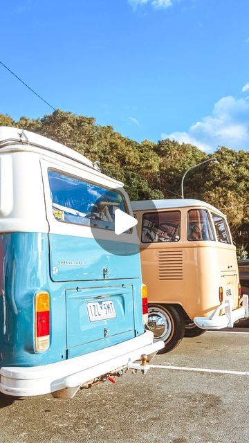 an old vw bus parked in a parking lot next to another van with the door open