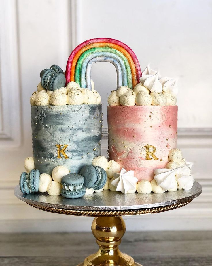 there is a cake that has been decorated with rainbows and clouds